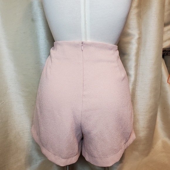 Pink shorts with pleated skirt overlay. - Picture 2 of 2